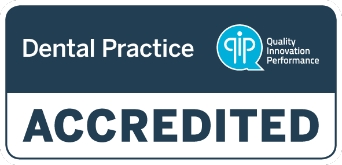 Aglow Accreditation badge for dental practices by Quality Innovation Performance (QIP), displaying the words 'Dental Practice Accredited' with the QIP logo in the top right corner on a dark blue background.